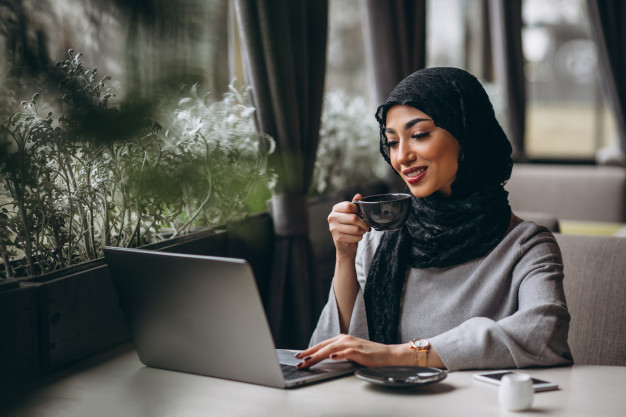 arabian-woman-hijab-inside-cafe-working-laptop_1303-14189.jpg